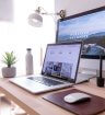 Picture of a laptop and computer at a desk